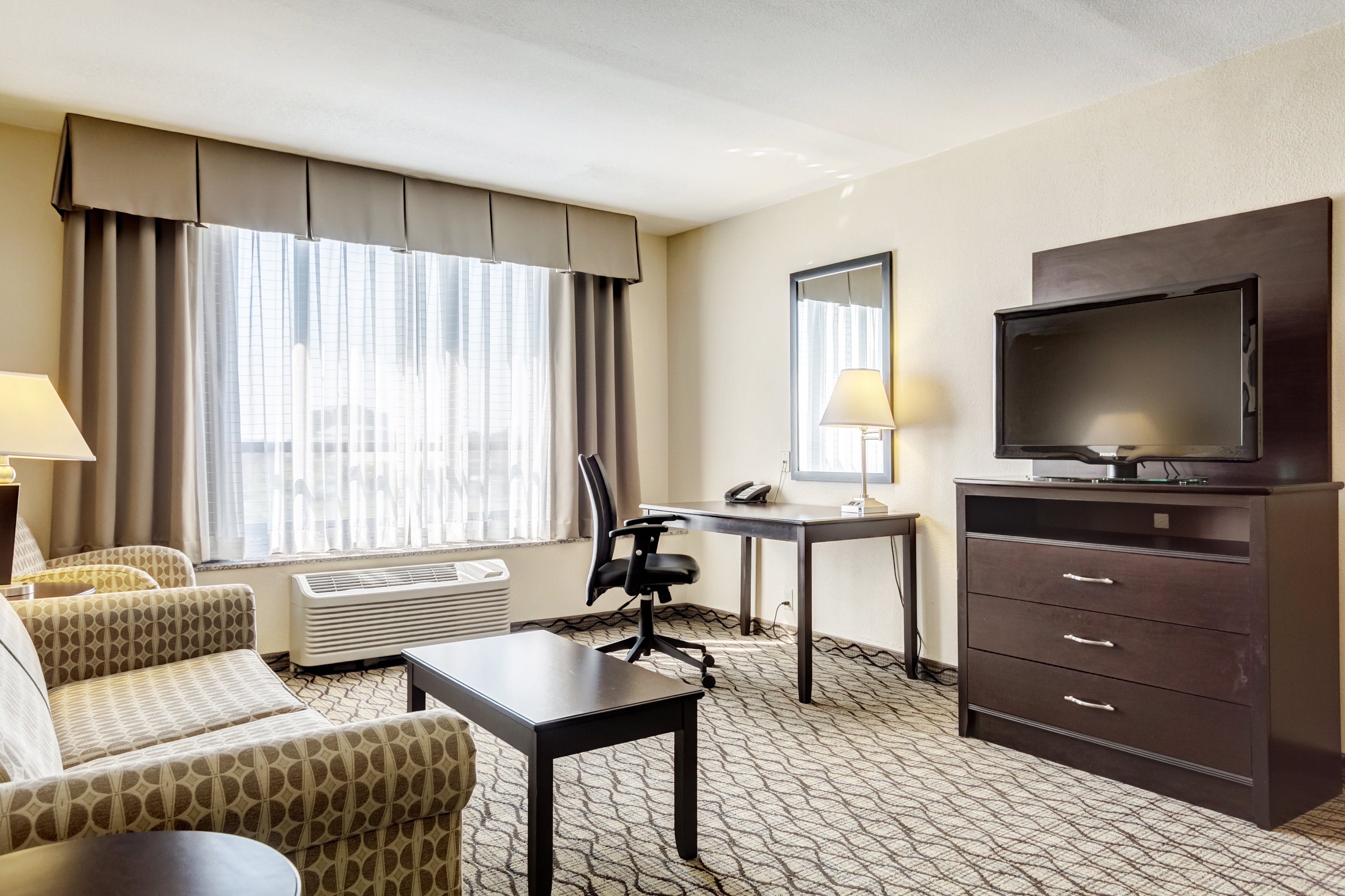 HOLIDAY INN ARPT W EARTH CITY-guestroom-King Suite Living Area.jpg