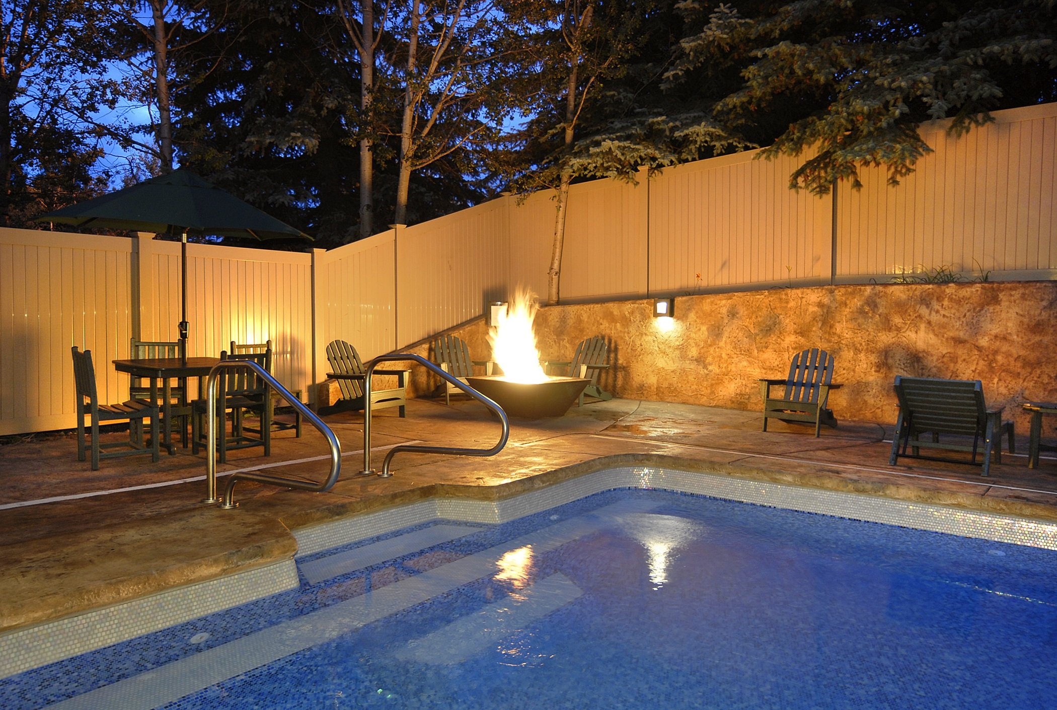 Outdoor Pool Zoomed In With Firepit Twilight