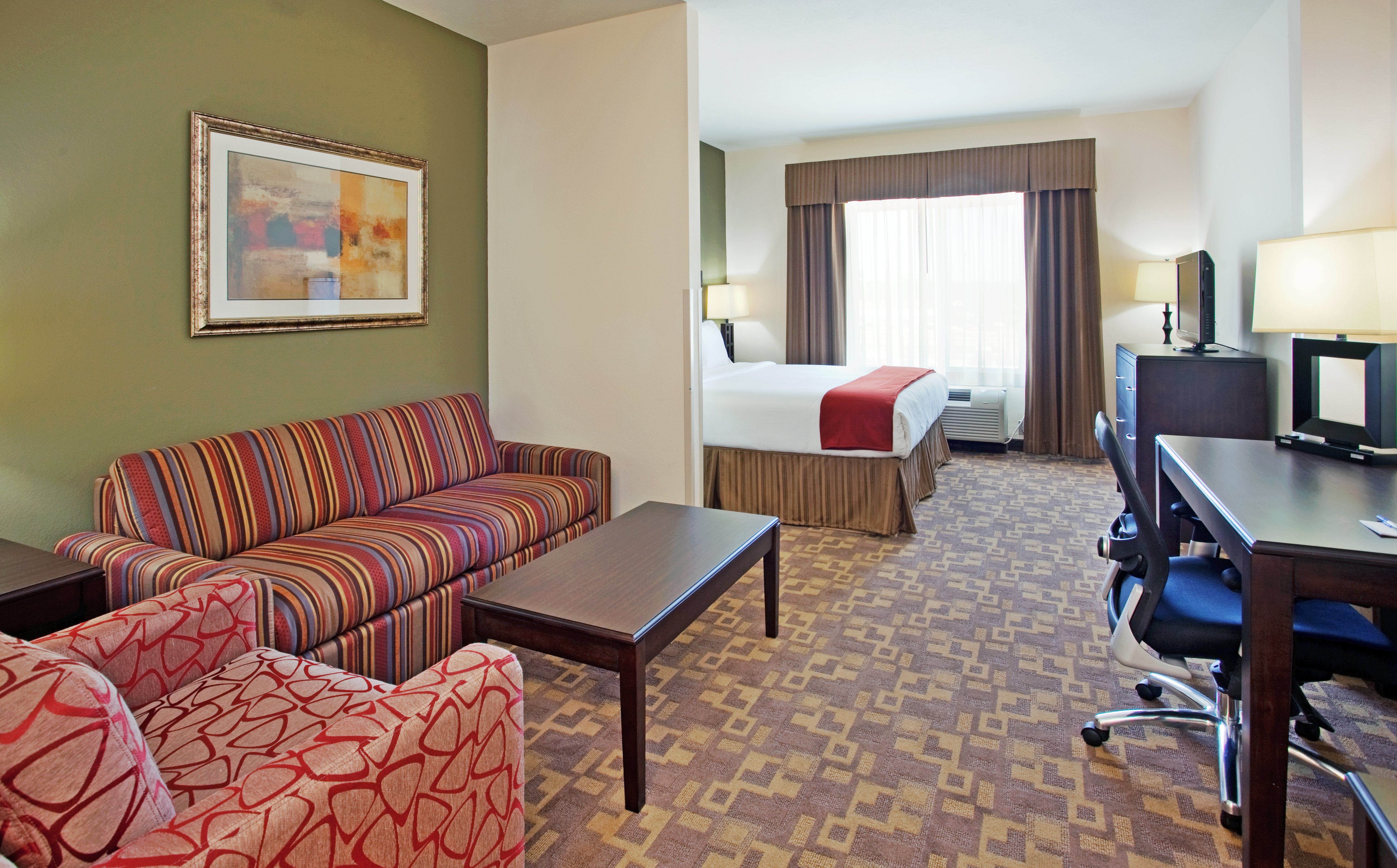 HOLIDAY INN EXP STES TOPEKA NO BY I-guestroom-Sitting area in the 1 King Bed Executive Suite.jpg