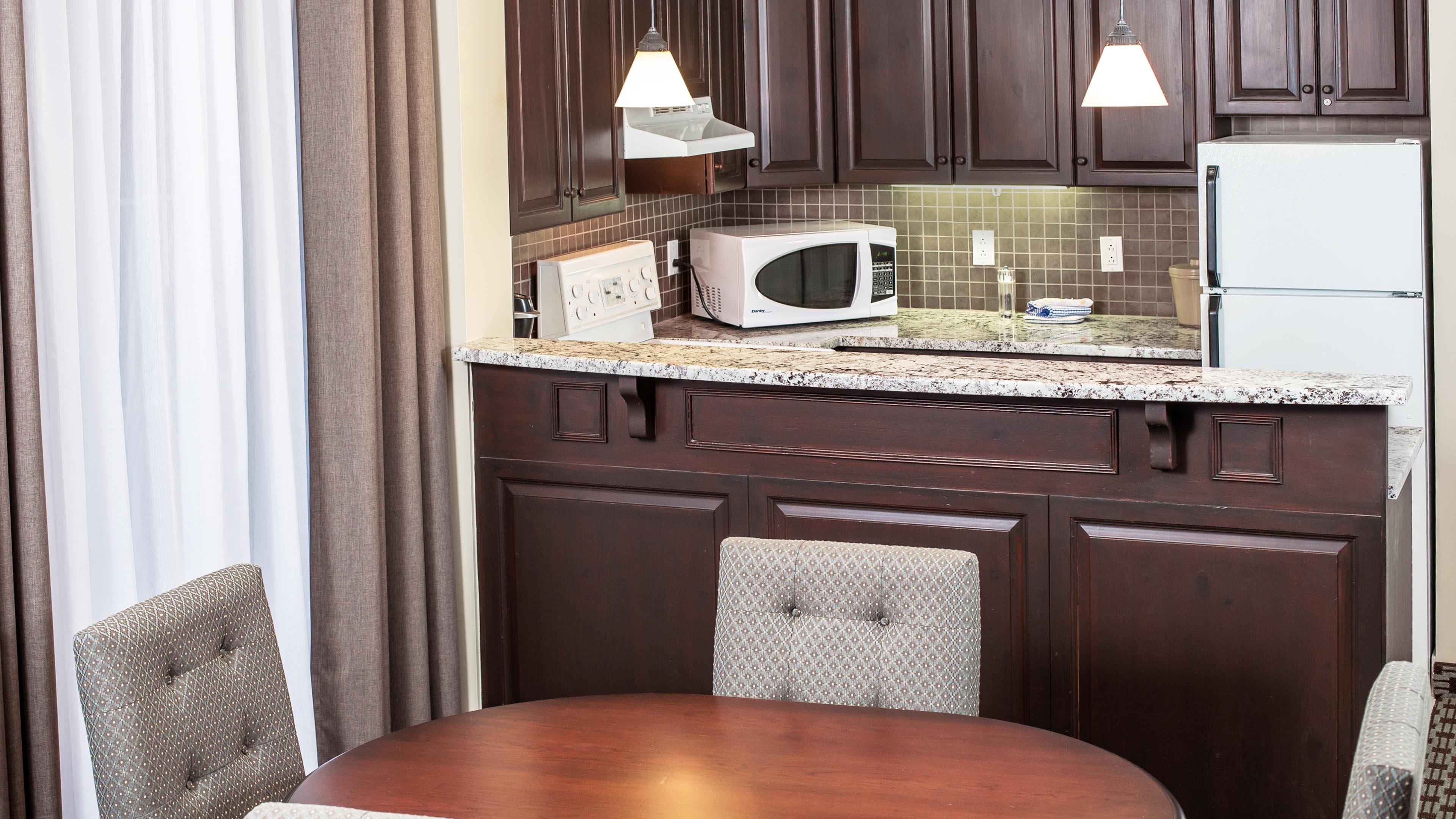 Suite features kitchen and dining area.