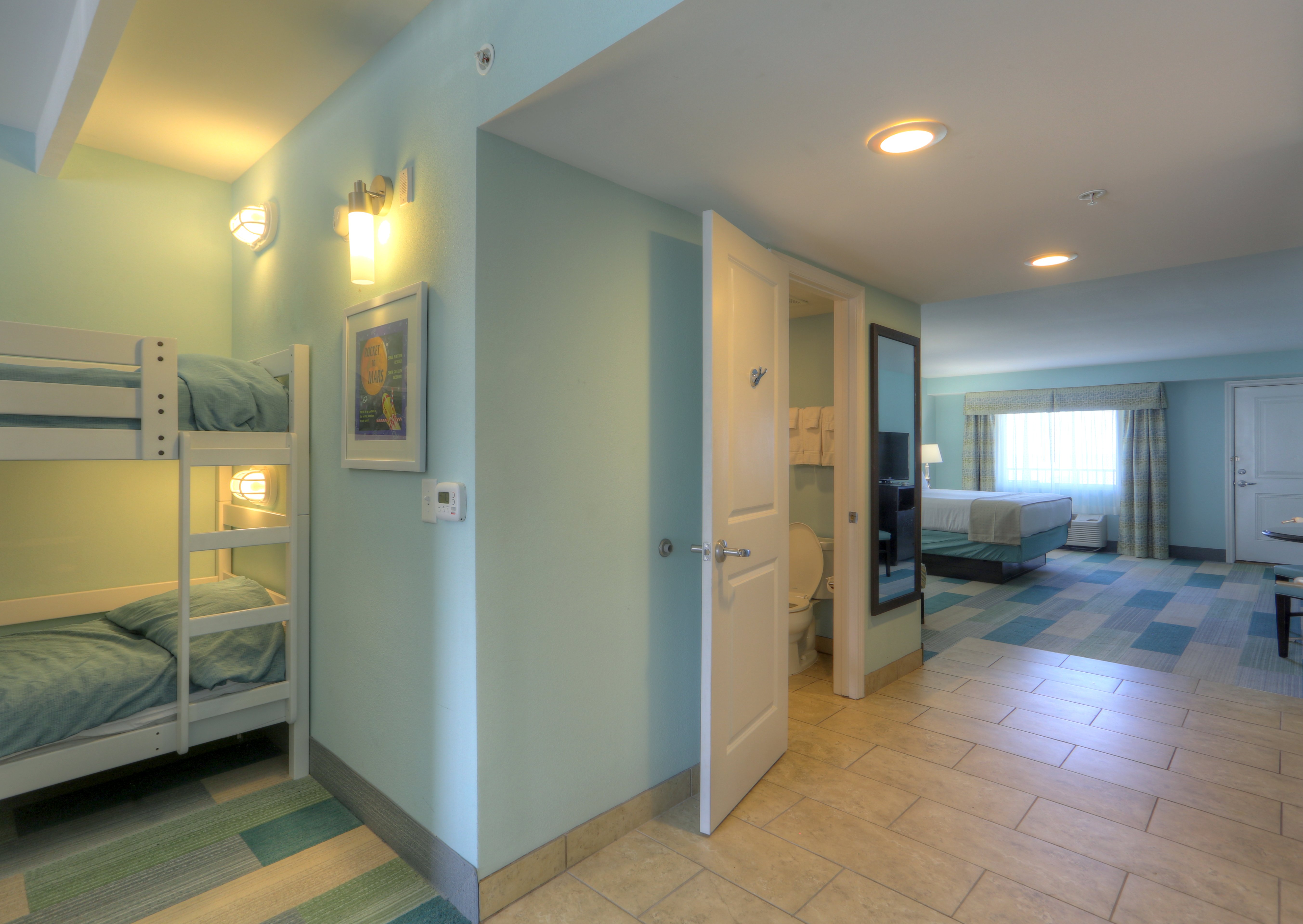 Our Kids Suites features a separate bedroom for parents.