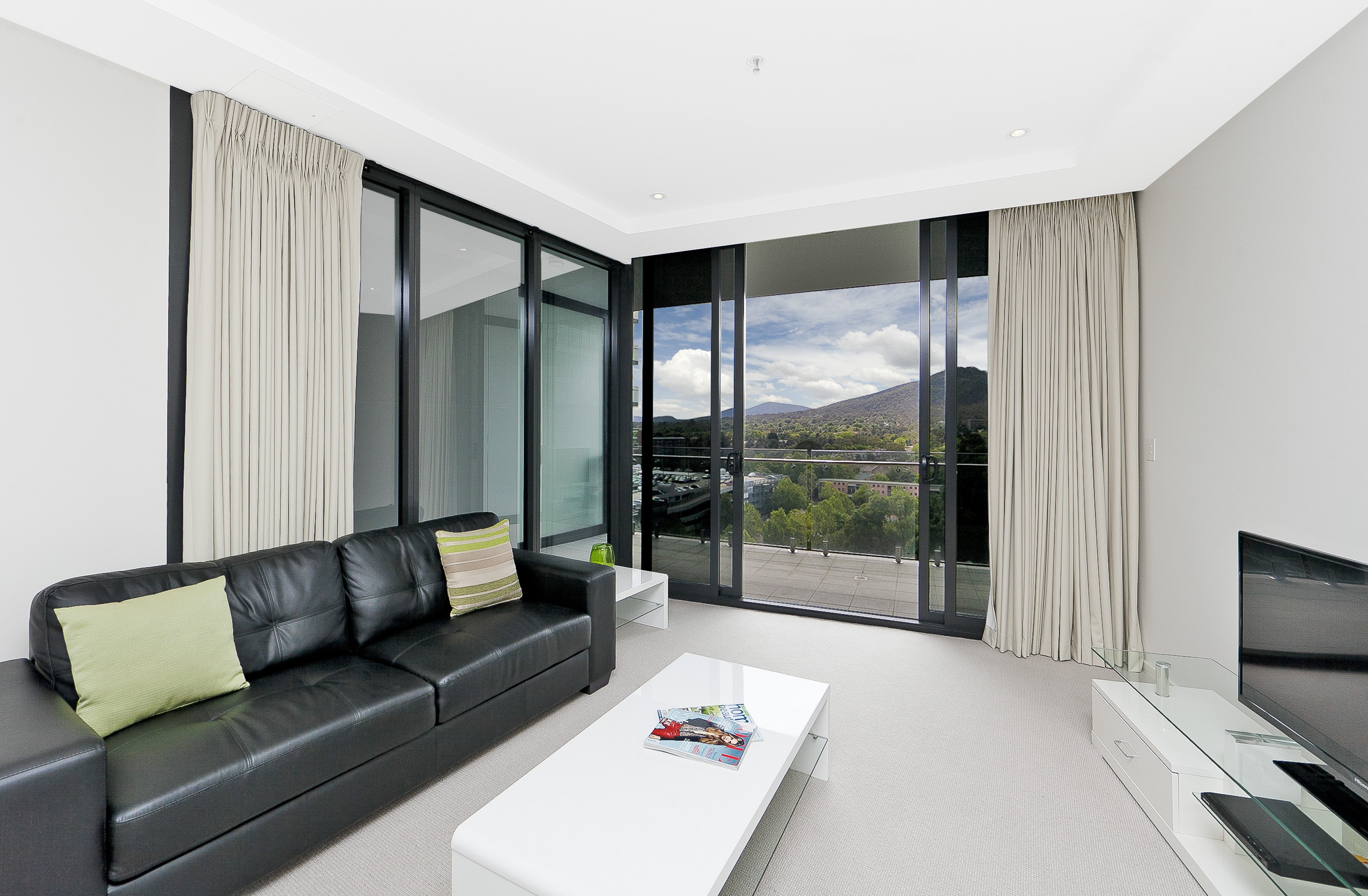 Astra Canberra CBD Manhattan-guestroom- One Bedroom Apartment Living Room.jpg