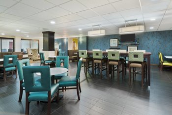 Ample plush seating with lots of outlets in breakfast area