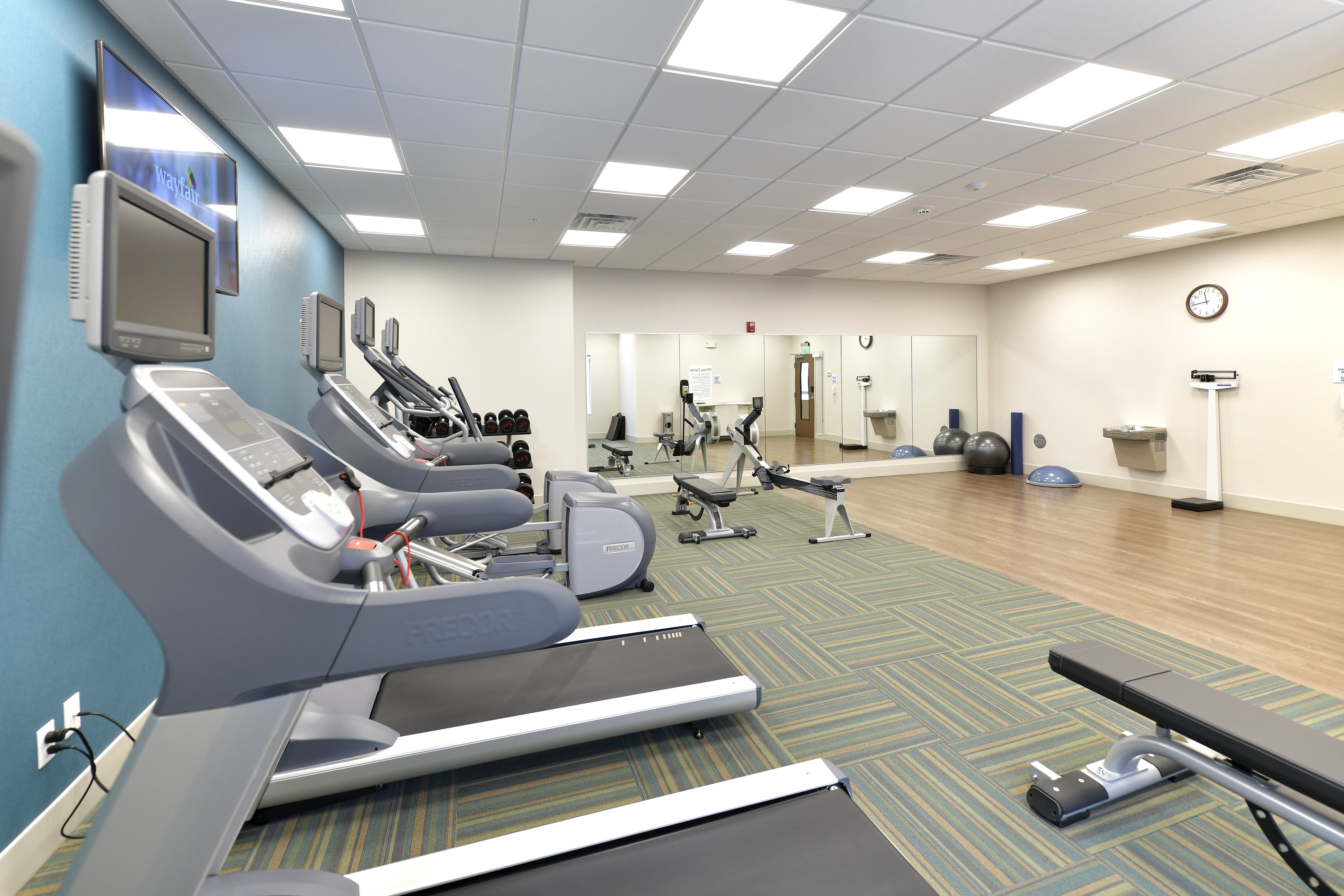 Fitness Room With Elliptical, Treadmill, Bike And Free Weights