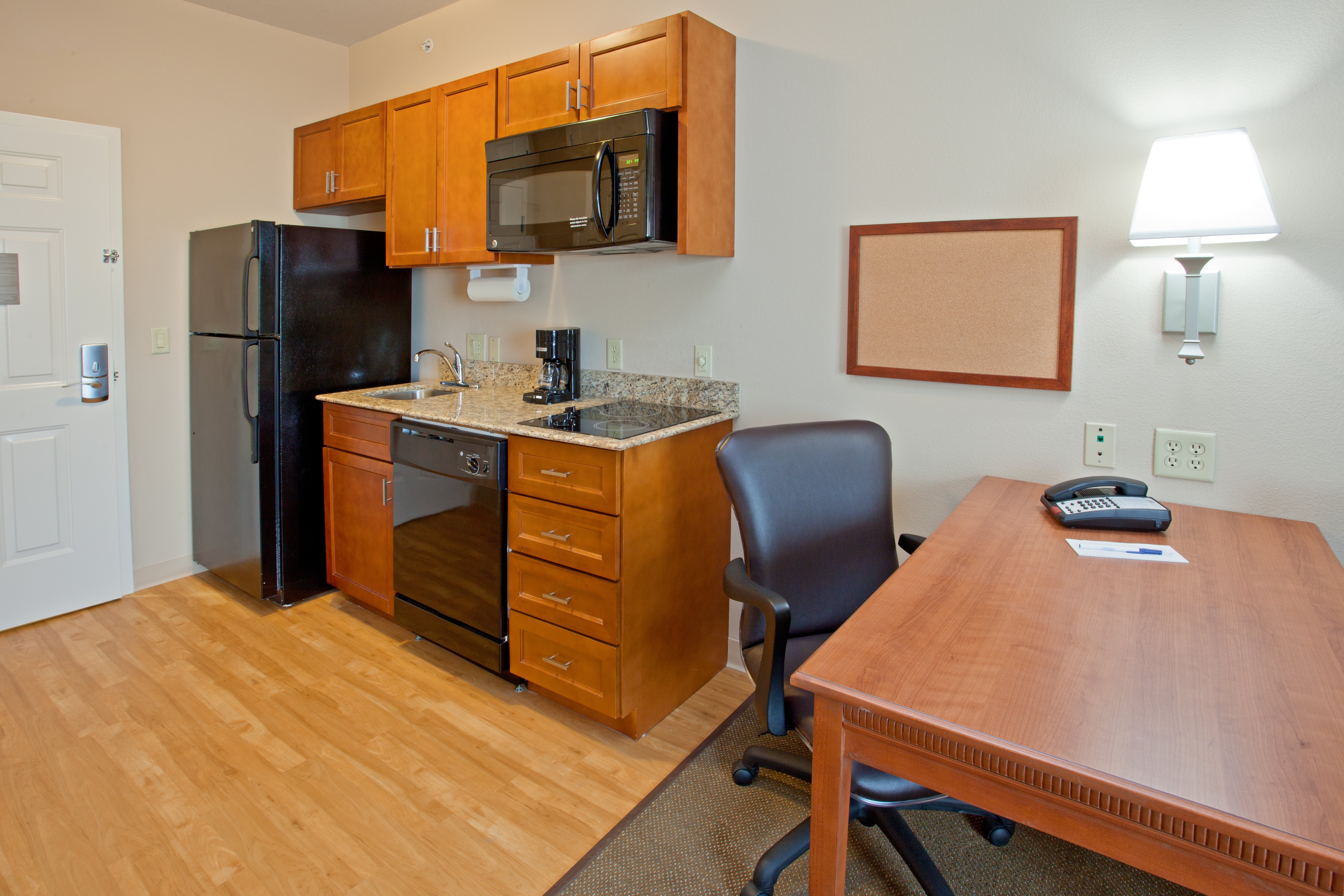 CANDLEWOOD SUITES LEAGUE CITY BY IH-guestroom-Full-size kitchen with refrigerator, stove top and microwave.jpg