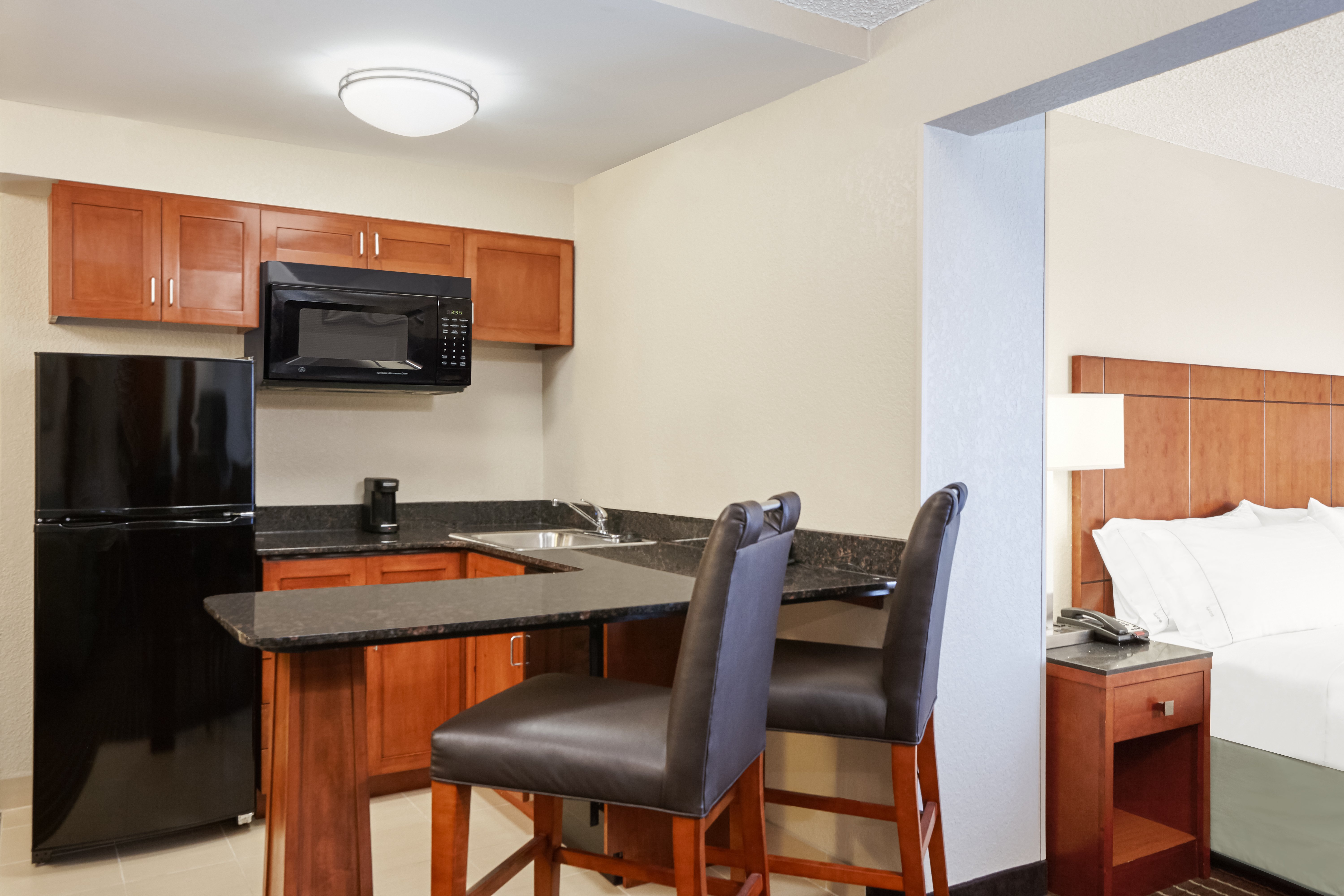 HOLIDAY INN COLISEUM CENTRAL BY IHG-guestroom-King Suite Kitchen.jpg