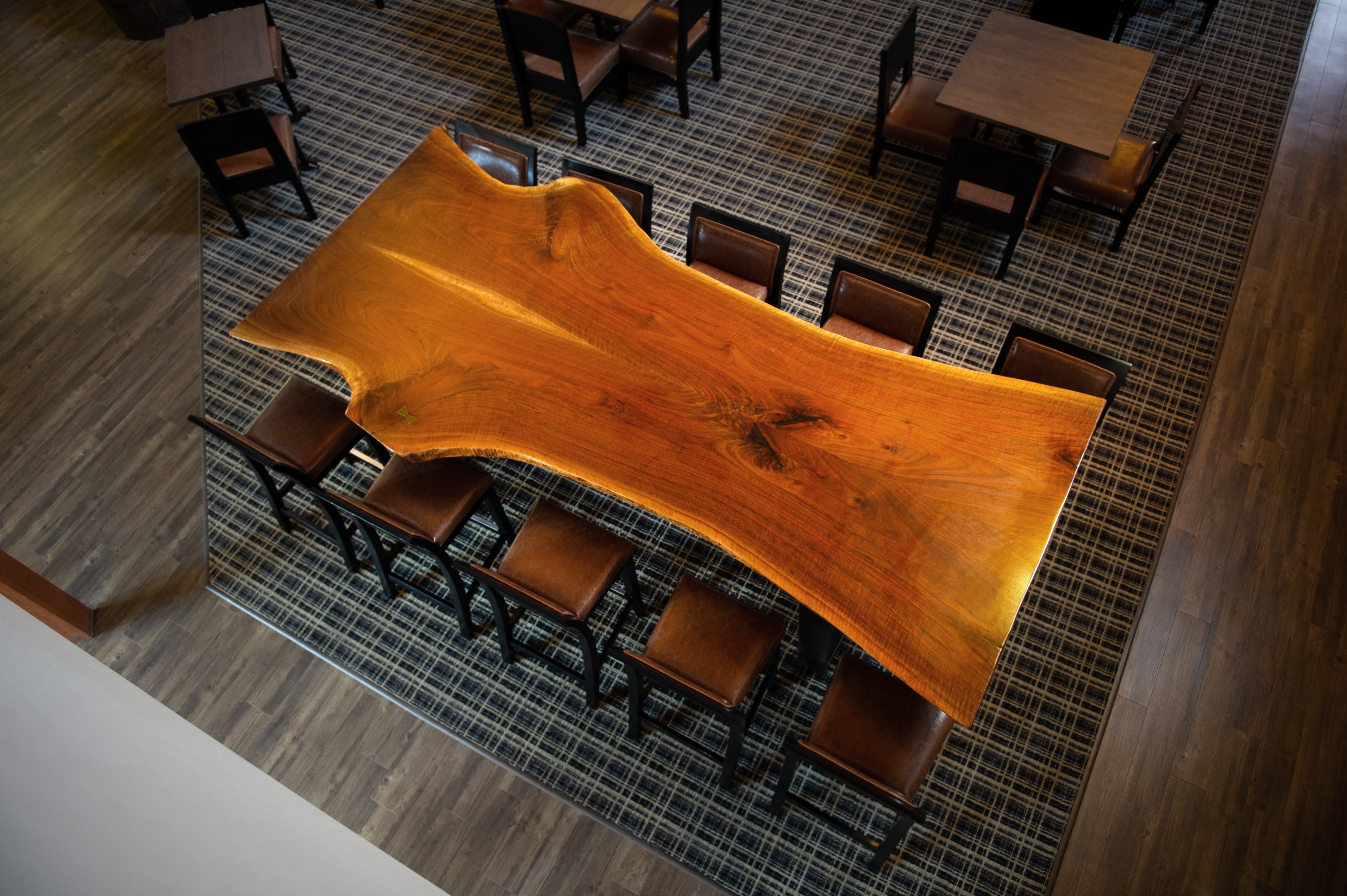 Large custom oak slab community dining table in the lobby