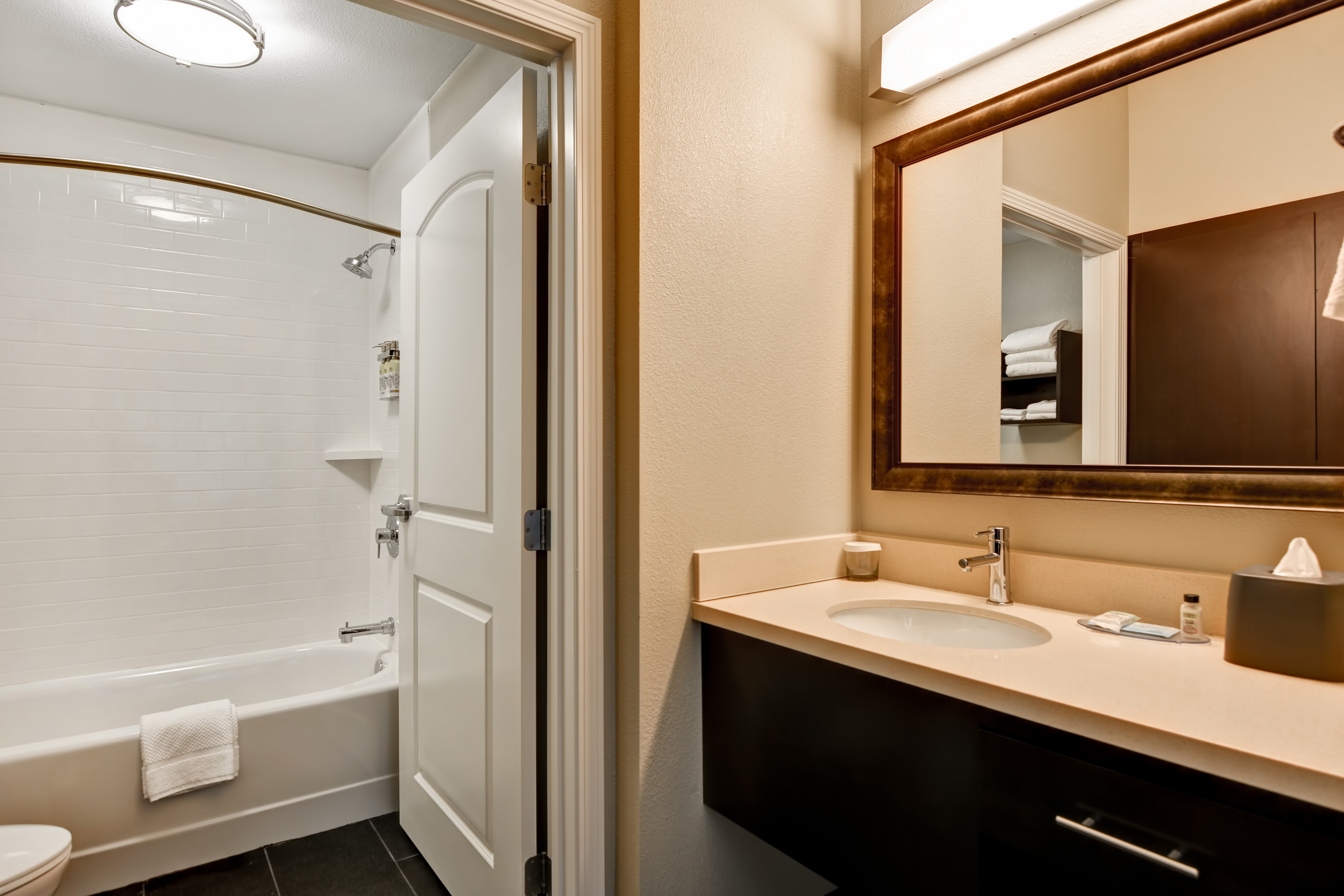 Spacious suite bathroom with bathtub & ample counter space. 