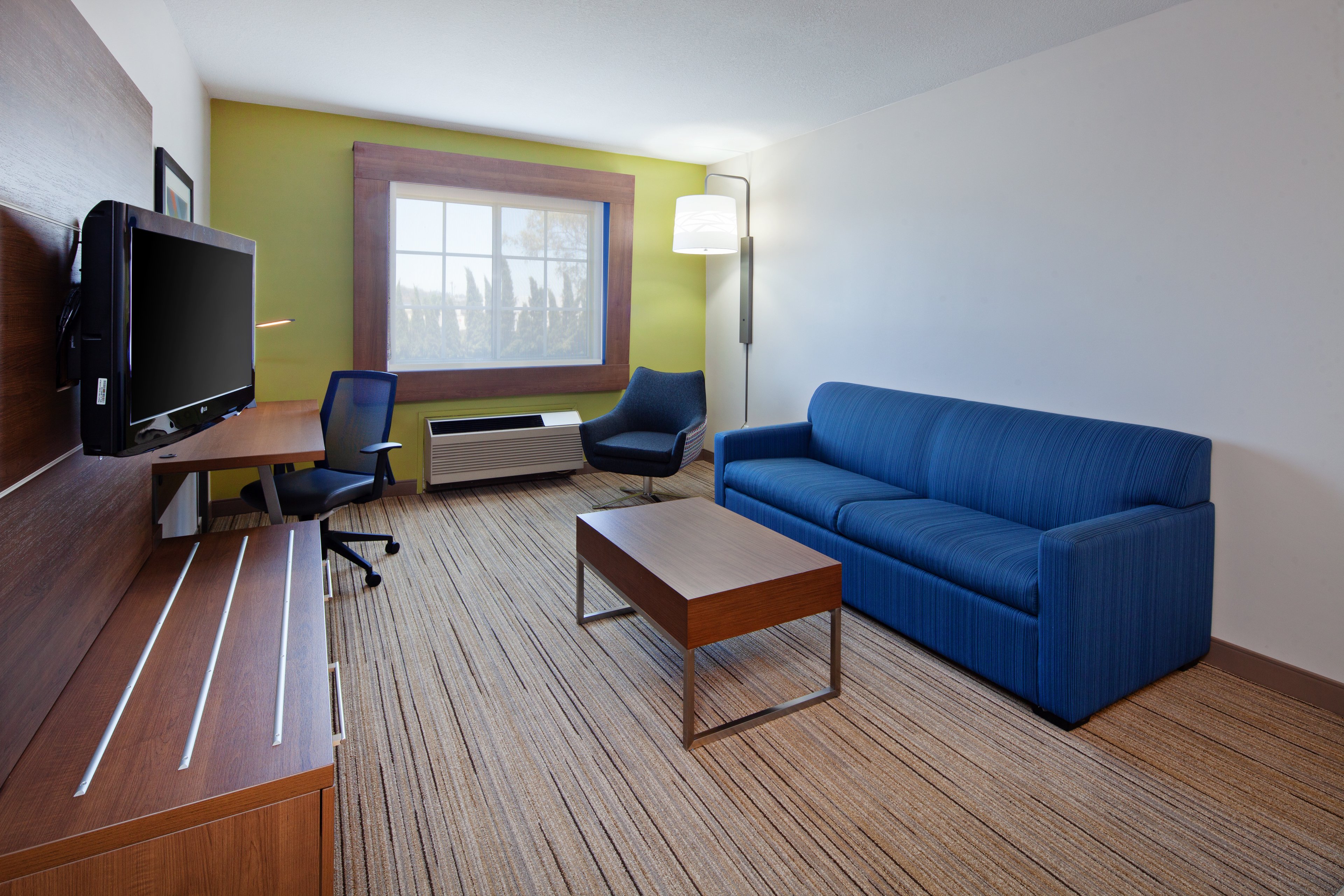 HOLIDAY INN EXP HTL AND STES BY IHG-guestroom-Enjoy extra space in the living room area with sofa bed..jpg