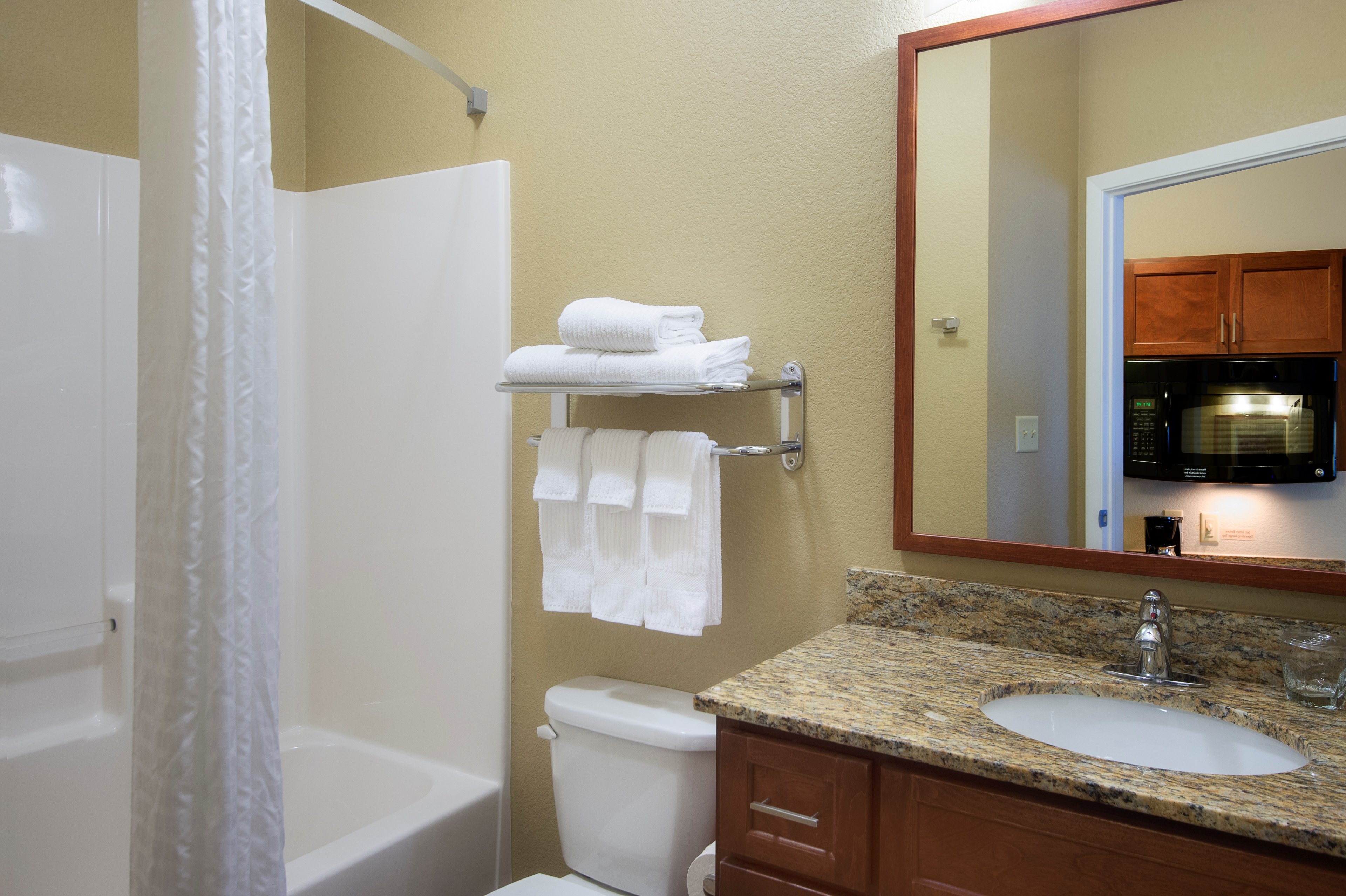 CANDLEWOOD SUITES - FT WORTH W BY I-guestroom-Guest Bathroom featuring granite counter tops.jpg