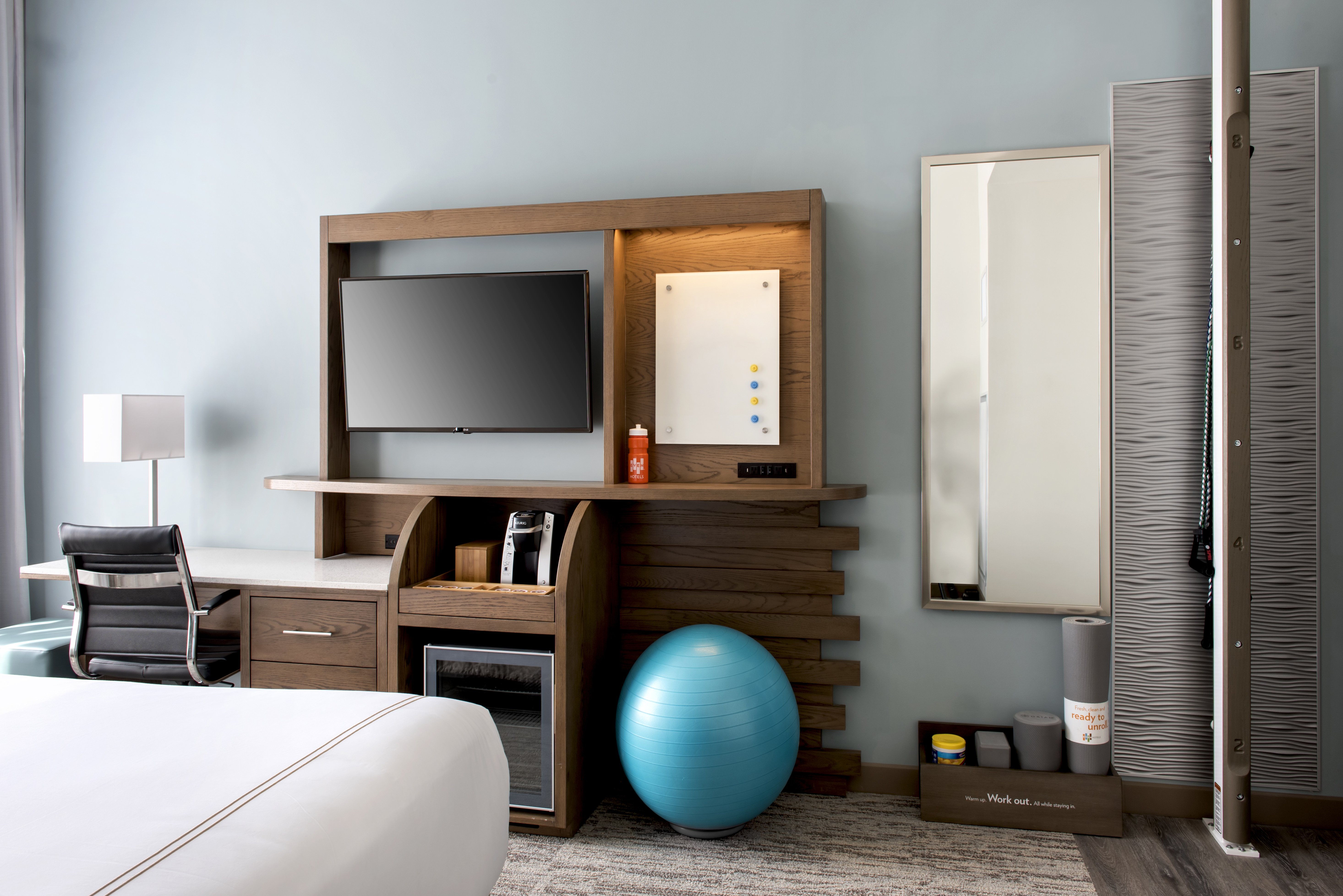 Rooms include a fitness zone and standing desk.