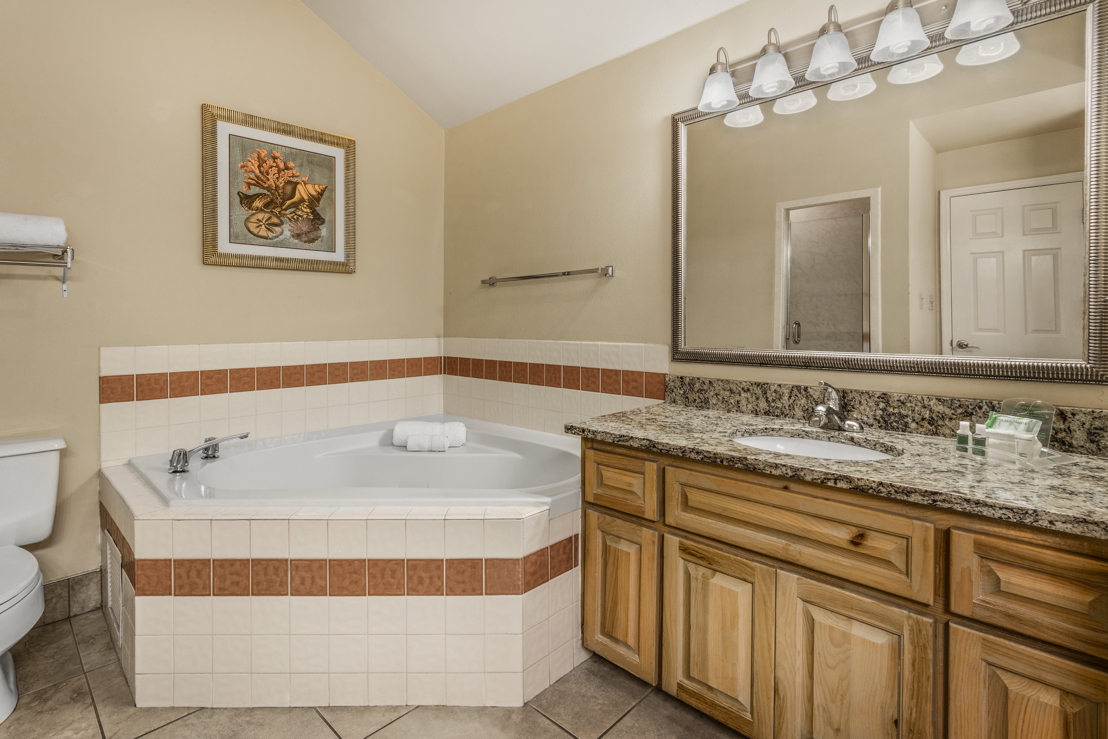 HOLIDAY INN HOTEL AND SUITES BY IHG-guestroom-Treat yourself to a rewarding stay in our king suite w/ jetted tub.jpg