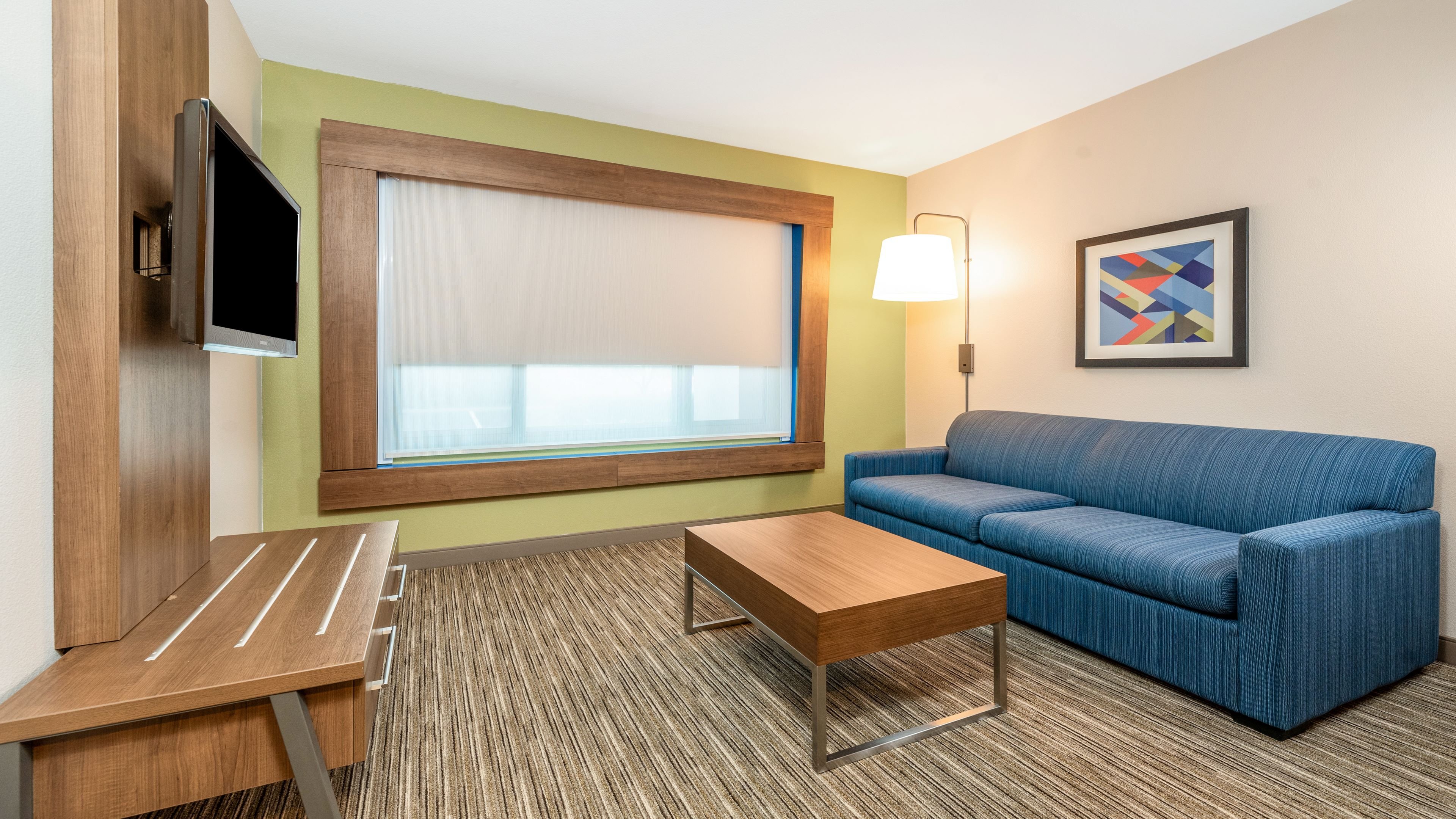 HOLIDAY INN EXP STES FREMONT BY IHG-guestroom-King Suite Living room area with sofa-sleeper.jpg