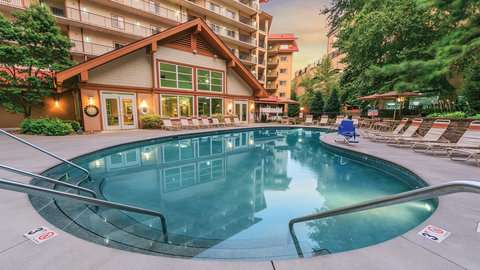 Outdoor pool surrounded by sunchairs.
