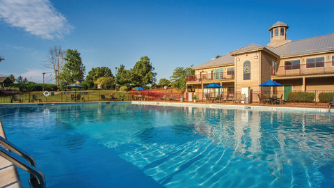 Exterior view of outdoor pool and property building.