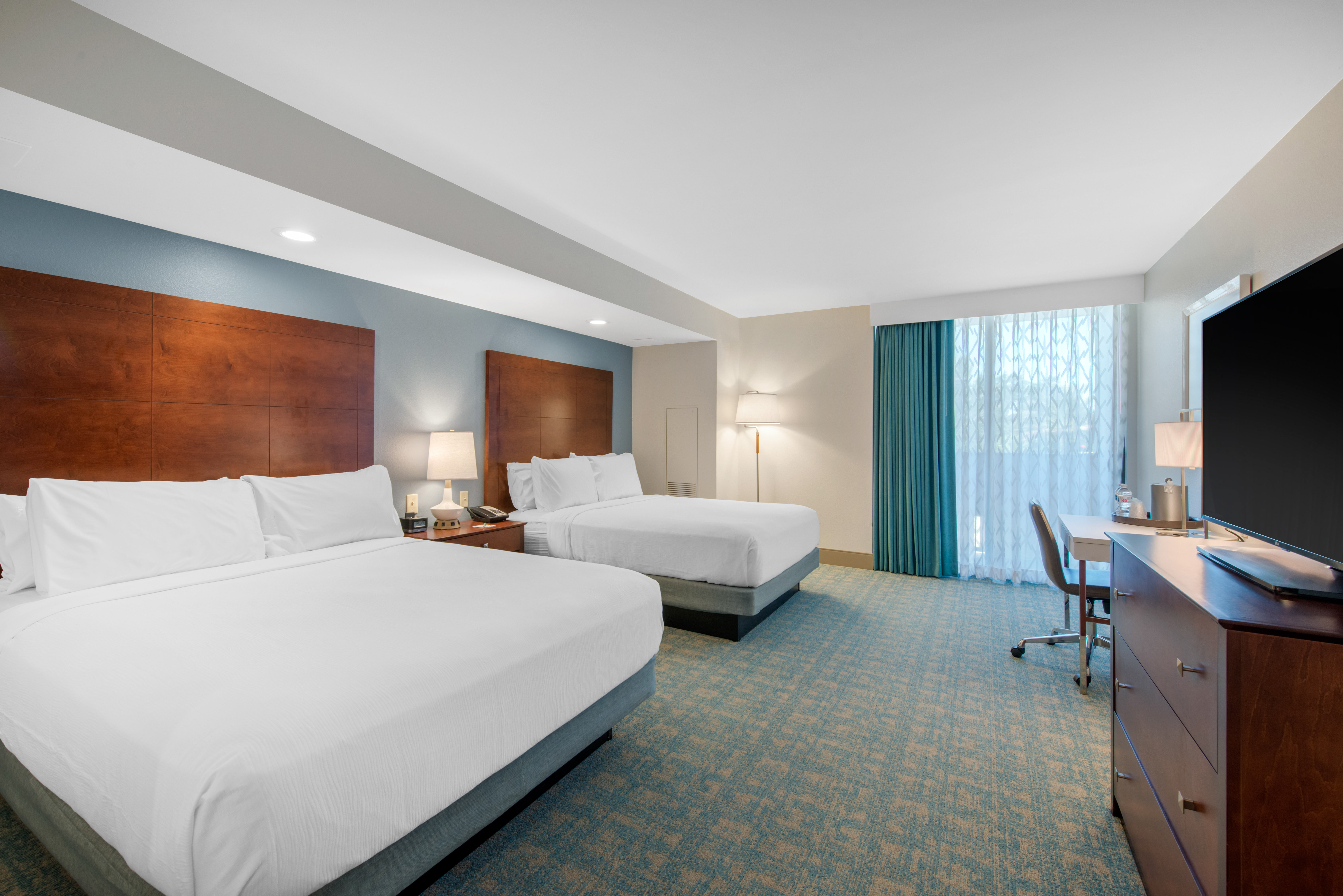 Guestrooms in the wing feature warm wood tone furniture
