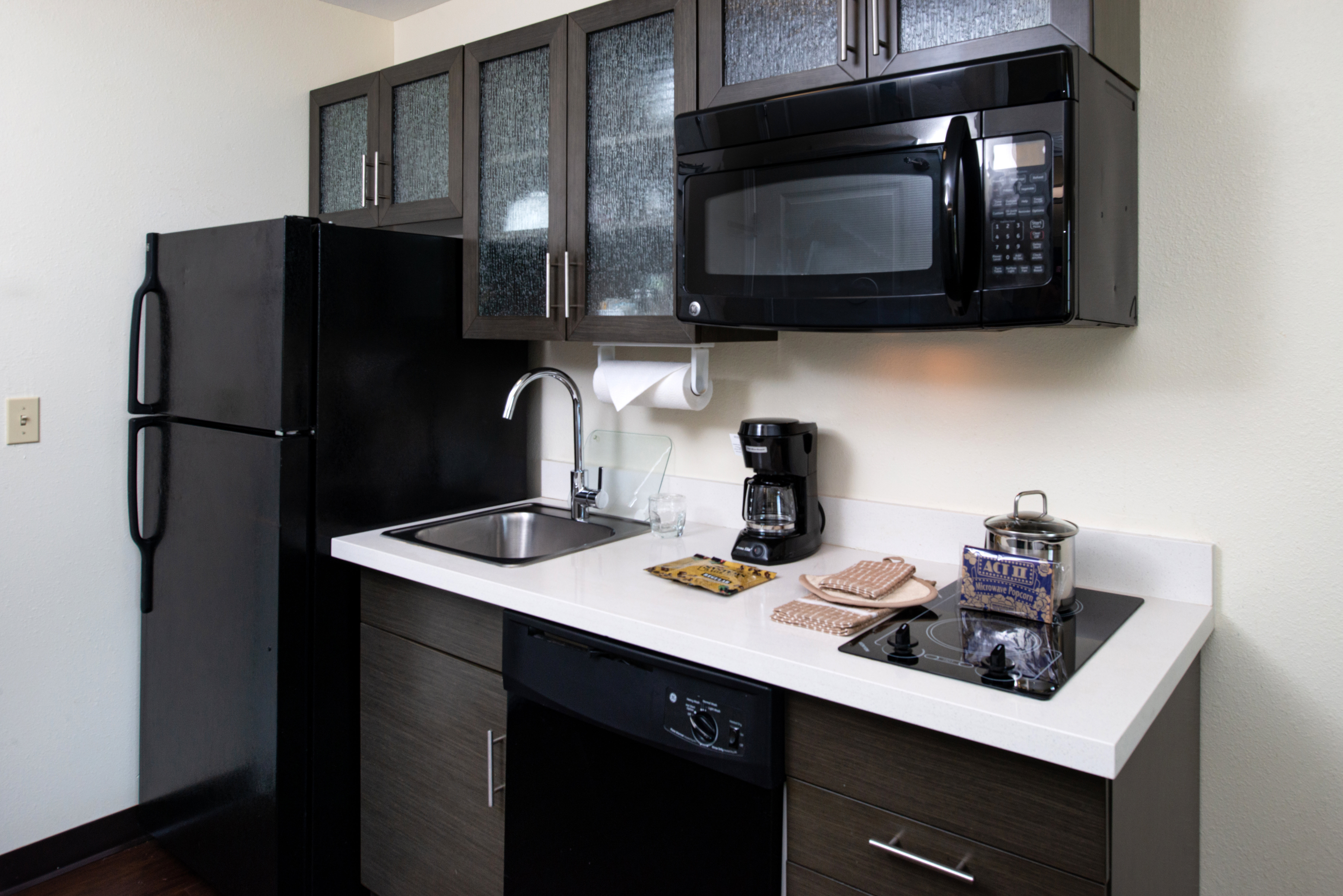 CANDLEWOOD SUITES OLATHE BY IHG-guestroom-Full-size kitchen with refrigerator, stove top and microwave.jpg