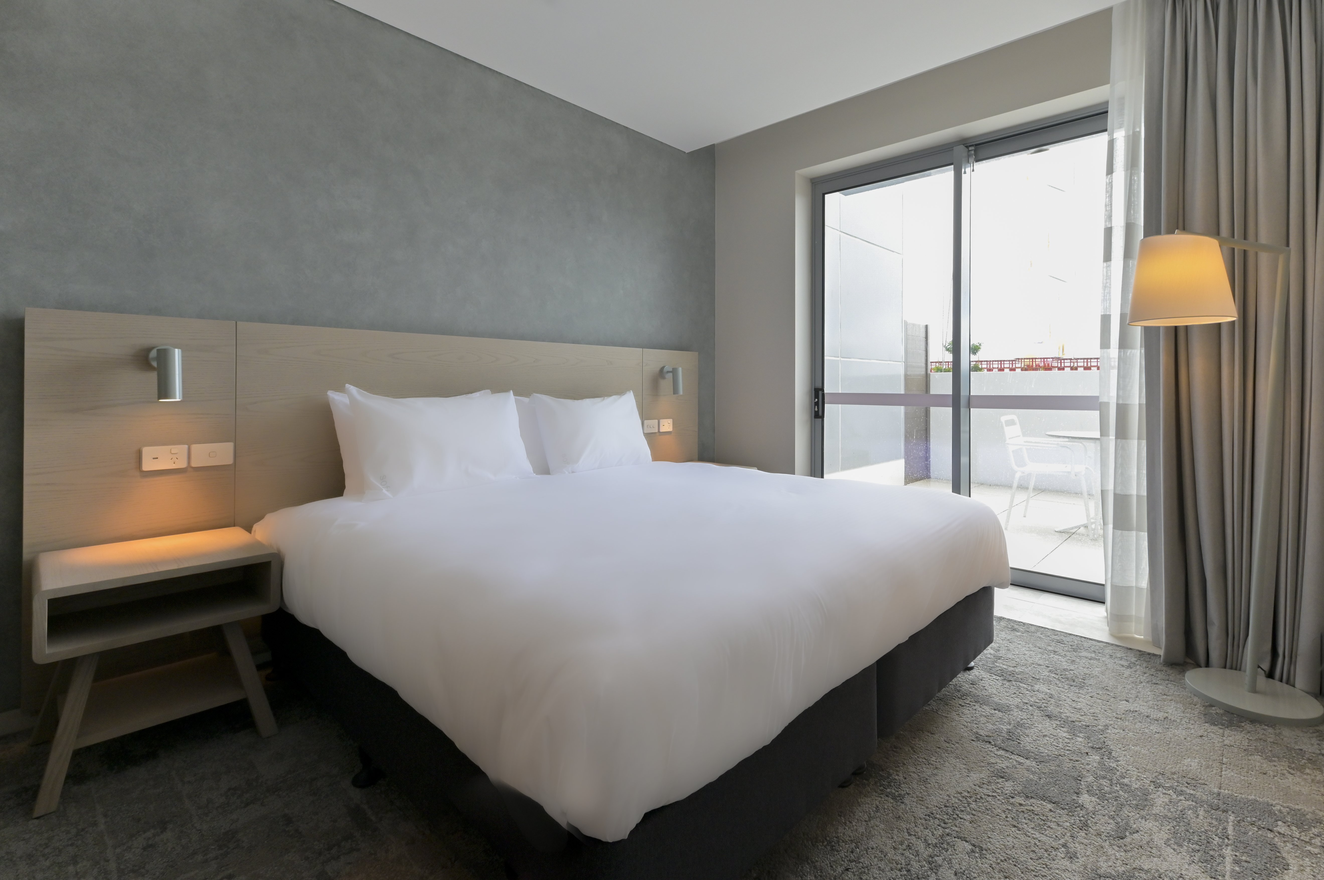 HOLIDAY INN EXP STES SUNSHINE COAST-guestroom-1 King Bed Suite Patio with Sofa Bed.jpg