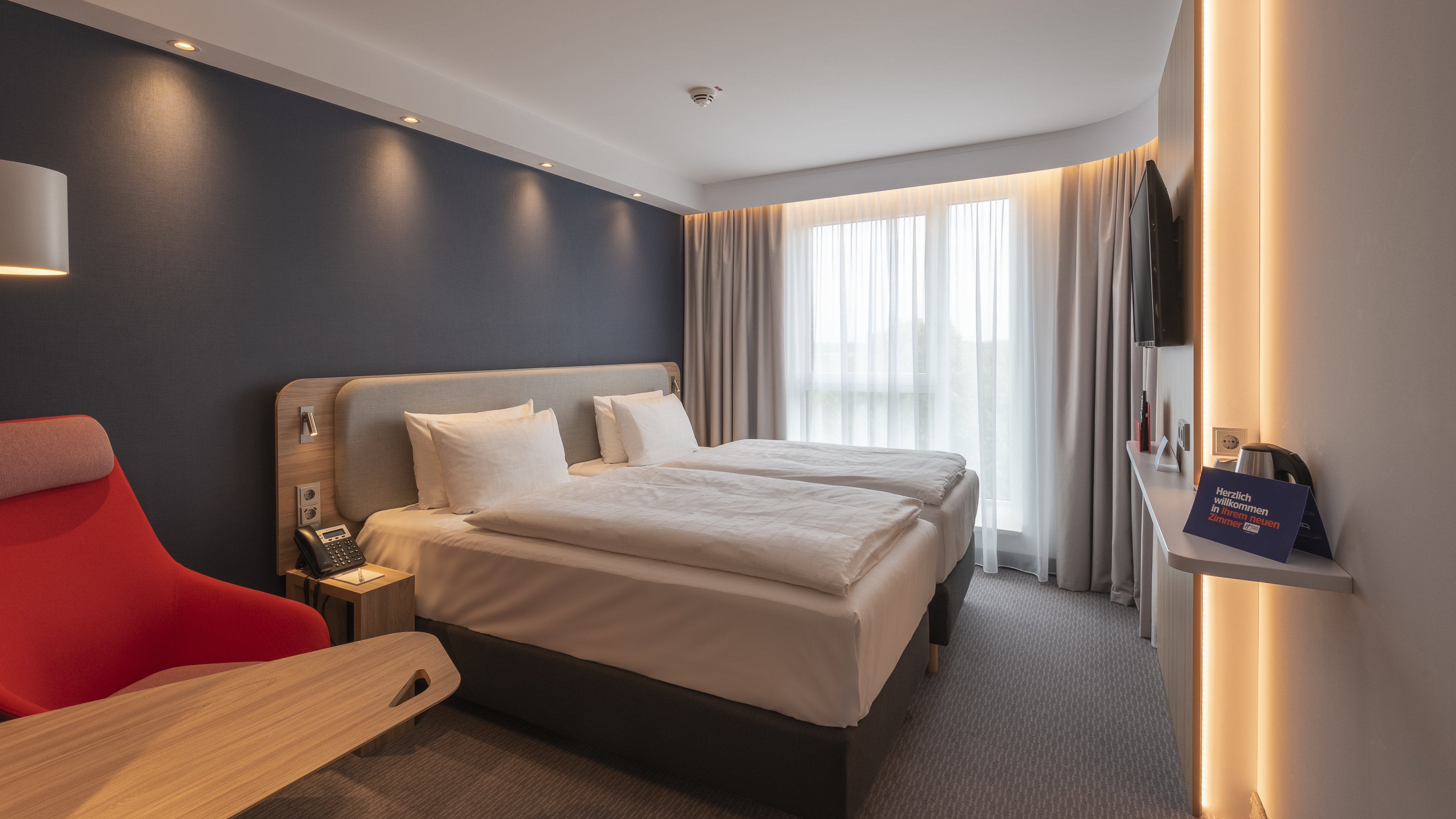 HOLIDAY INN EXP KREFELD DUSSELDORF-guestroom-Two twin beds with moveable desk and chair.jpg