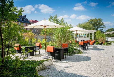 Outdoor dining in the beautiful garden at Elite Hotel Arcadia