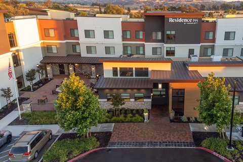 Exterior view of hotel at sunset with mountains