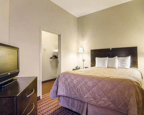 Affordable Suites of America R-guestroom-SNQQ Queen Bedroom Suite.jpg