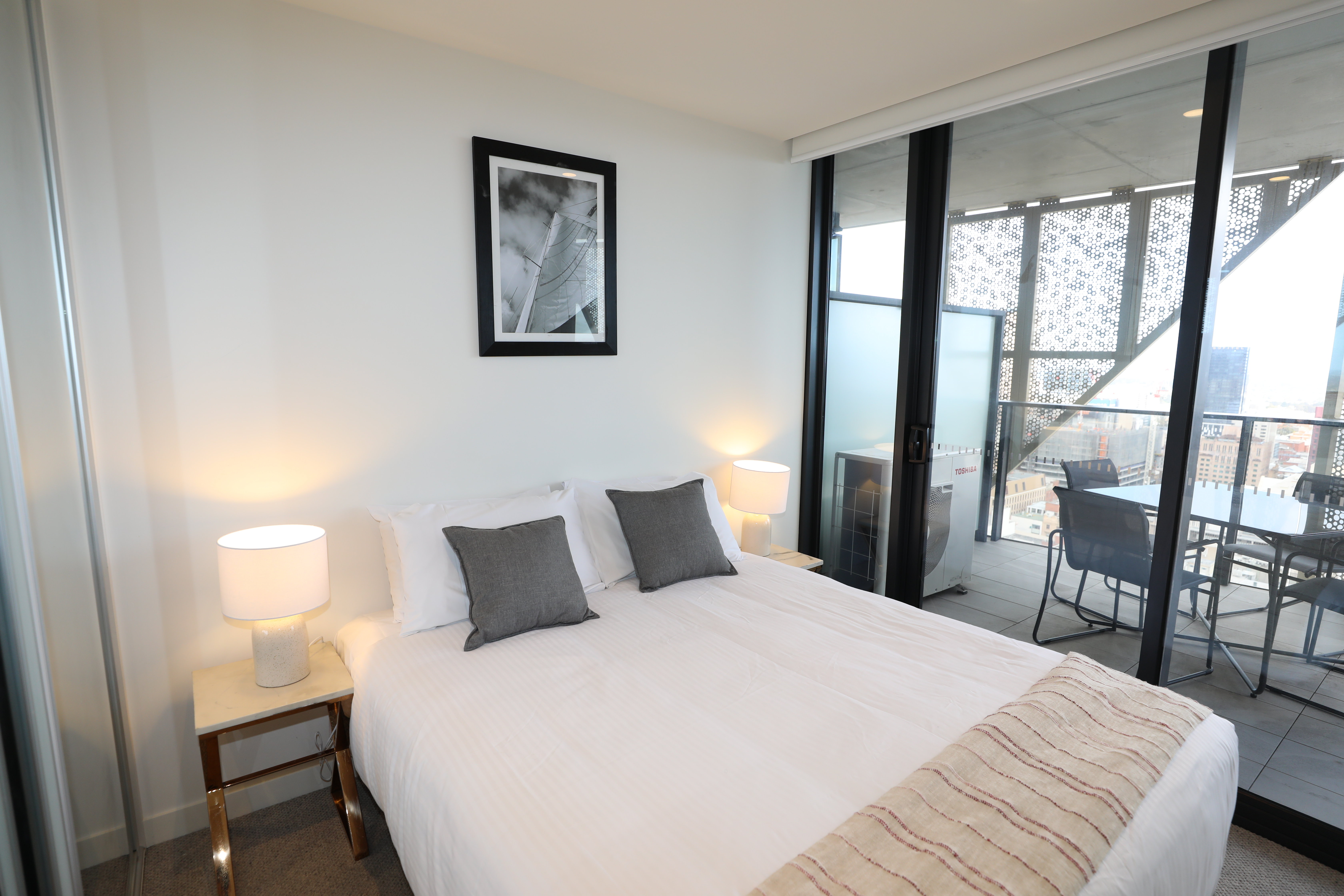 Realm Apartments by CLLIX-guestroom-One Bedroom Apartment - Bed.jpg