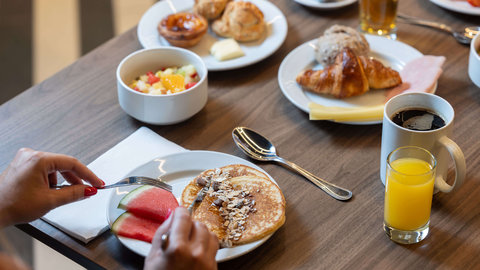 Selection of breads, fruit, and breakfast beverages