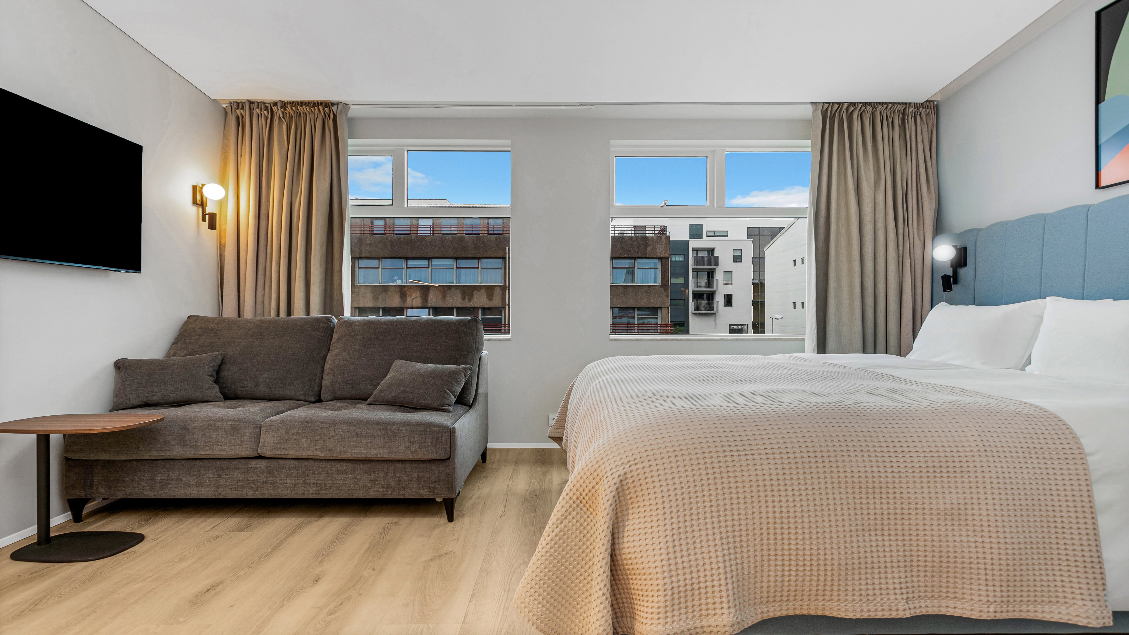 CANDLEWOOD STES REYKJAVIK BY IHG-guestroom-Modern guest room featuring cozy sofa bed and comfortable king bed.jpg