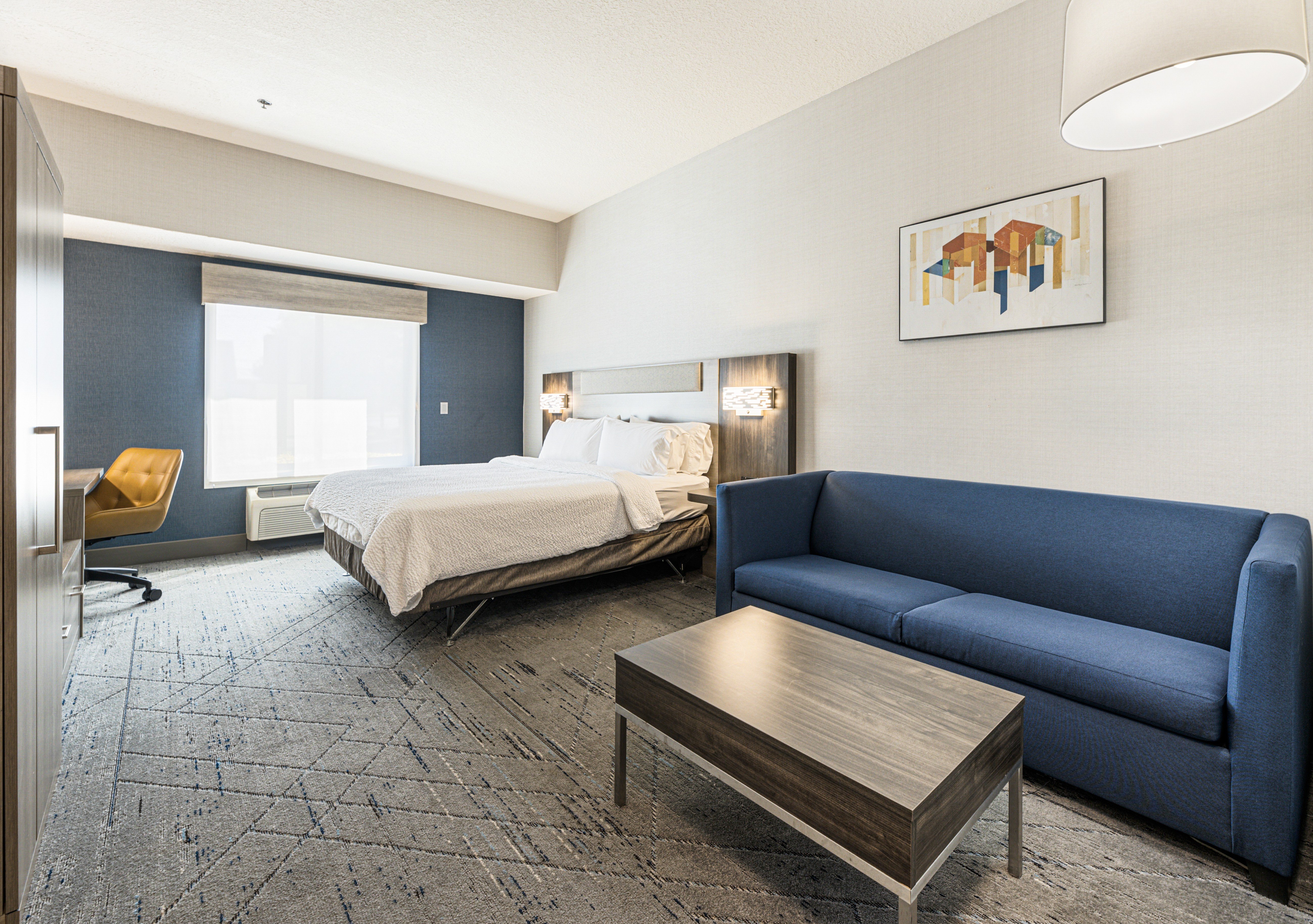 HOLIDAY INN EXP STES LAKE LANIE BY-guestroom-Sweet dreams guaranteed with a king bed and a sofa bed.jpg